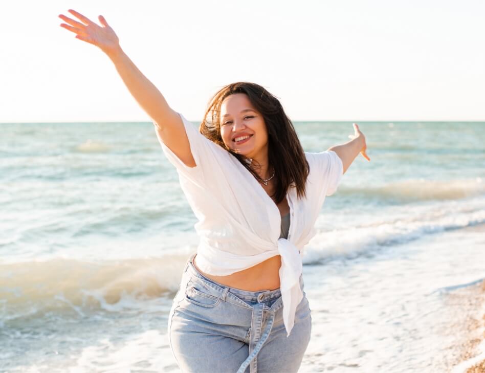 happy-woman-having-fun-at-beach-2025-03-08-16-34-31-utc (1)